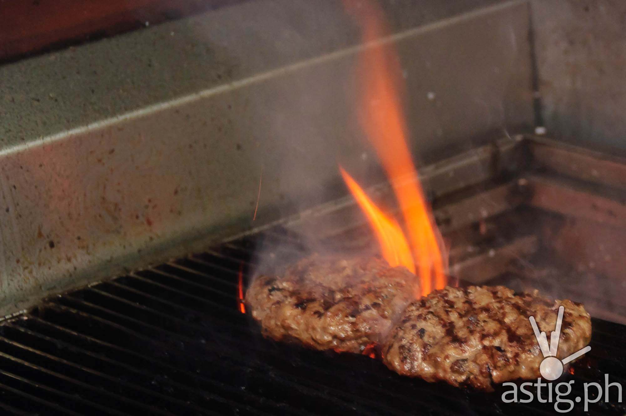 Burger patties being cooked at Wham! Burgers MOA