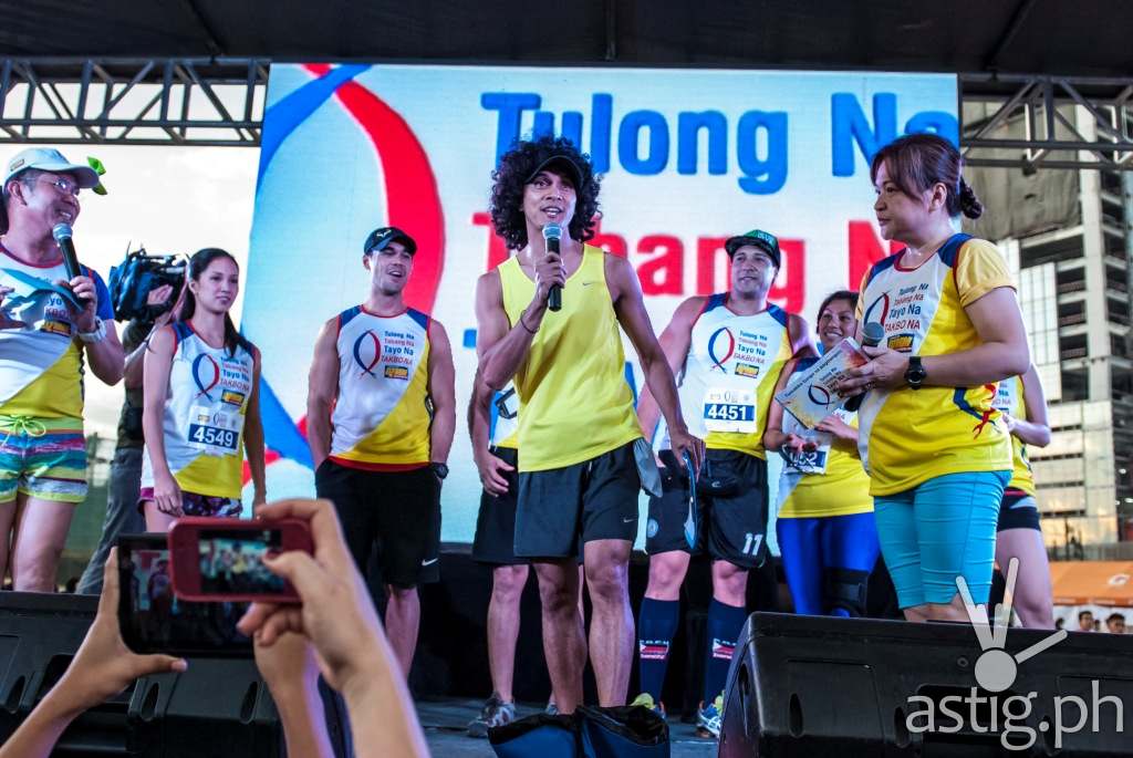 Rio dela Cruz speaks during the DZMM Takbo Na color fun run's pre-race program