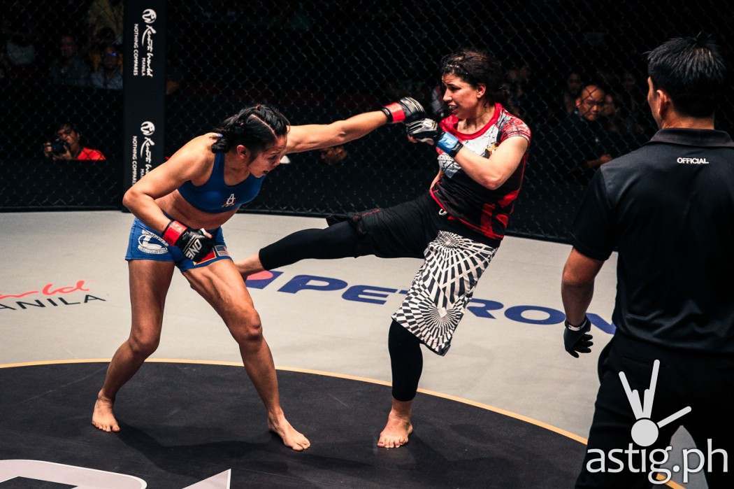 Ana Julaton delivers a left straight while Walaa Abbas connects with an outside right leg sweep