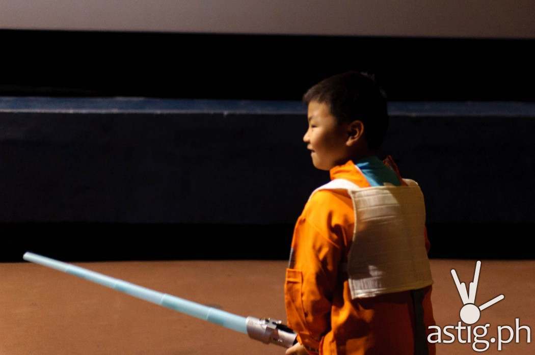 A young Jedi in training all suited up and ready to use The Force