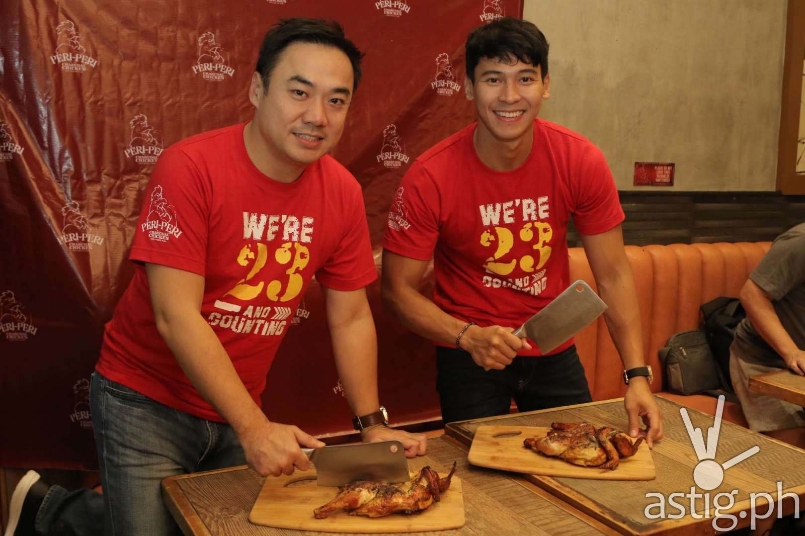 Bryan Tiu and Enchong Dee at the ceremonial chicken chopping for the grand opening of the newly-relocated Peri-Peri Charcoal Chicken and Sauce Bar at Venice Grand Canal Mall, McKinley, BGC.