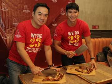 Bryan Tiu and Enchong Dee at the ceremonial chicken chopping for the grand opening of the newly-relocated Peri-Peri Charcoal Chicken and Sauce Bar at Venice Grand Canal Mall, McKinley, BGC.