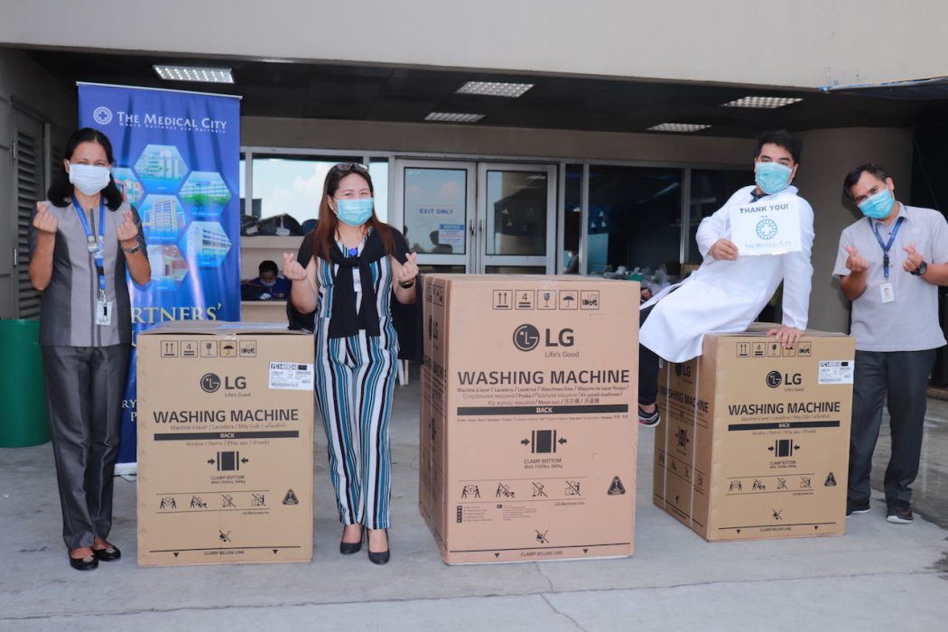 The Medical City staff gamely poses with the 3 LG washing machines donated in celebration of National Health Workers Day and Labor Day - LG Philippines