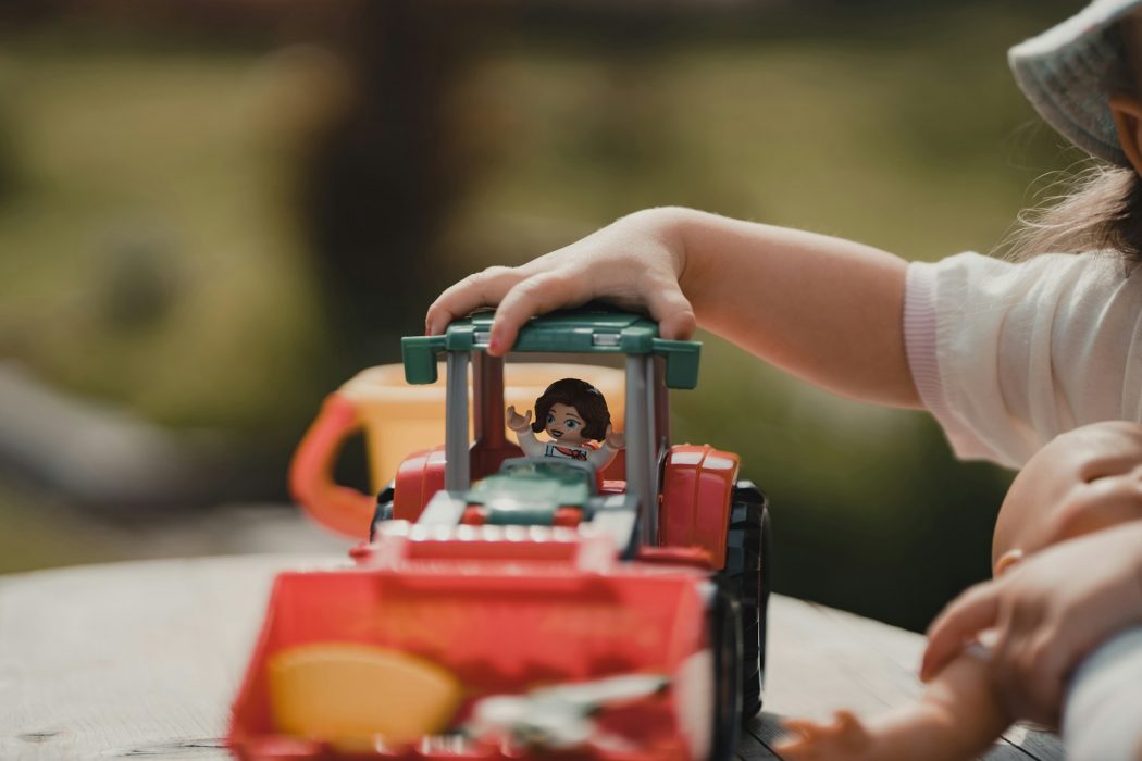 a small child playing with a toy truck